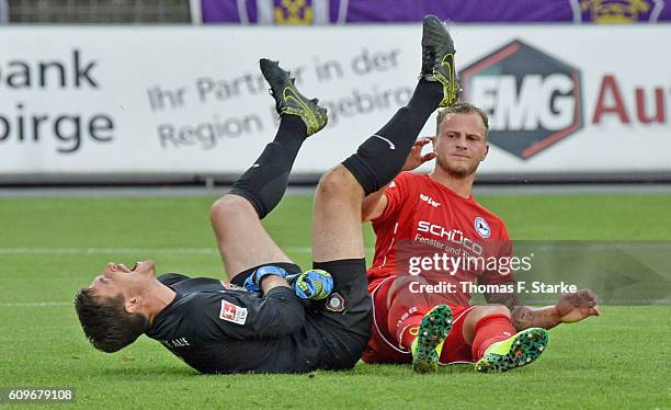 Christoph Hemlein of Bielefeld clashes with goalkeeper Martin Maennel during the Second Bundesliga match between FC Erzgebirge Aue and DSC Arminia...