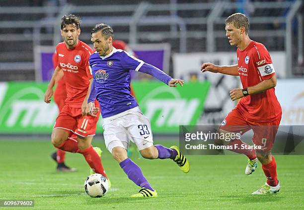 Stephan Salger and Fabian Klos of Bielefeld tackle Christian Tiffert of Aue during the Second Bundesliga match between FC Erzgebirge Aue and DSC...