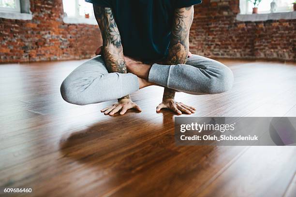 mann macht yoga im studio - frau macht yoga stock-fotos und bilder