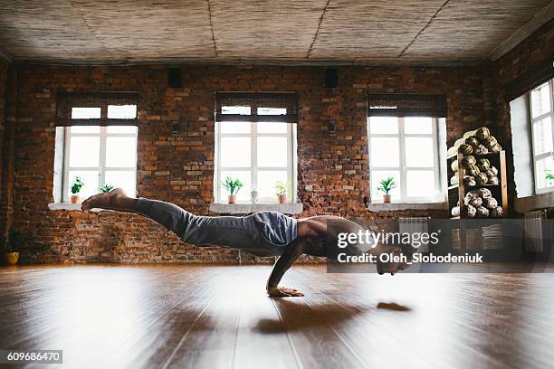 man doing yoga in studio - upright position stock pictures, royalty-free photos & images