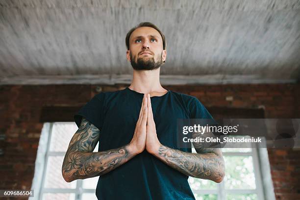 man doing yoga in studio - man doing yoga in the morning stockfoto's en -beelden