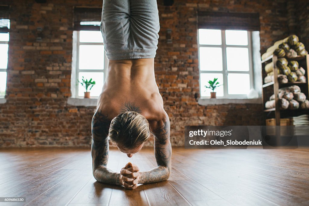 Man doing yoga in studio