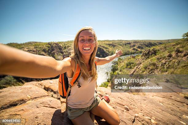 self portrait of young woman traveling - blonde woman selfie stockfoto's en -beelden