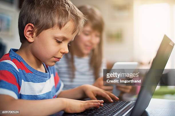 little boy and girl learning to code at home - editing room stock pictures, royalty-free photos & images