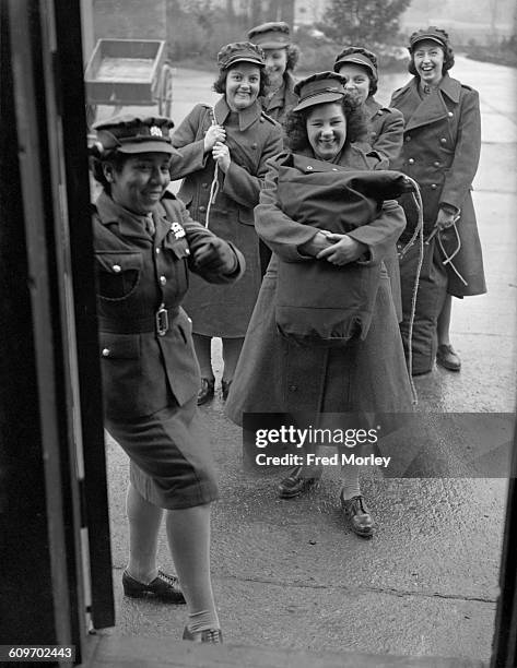 Corporal Hinds of the British Auxiliary Territorial Service , introduces new recruits to the service to their sleeping quarters at a training centre...