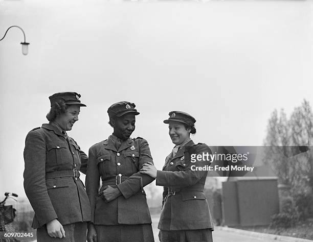 Lance Corporal Adina Williams of the British Auxiliary Territorial Service , is congratulated by members of her unit after receiving her first...