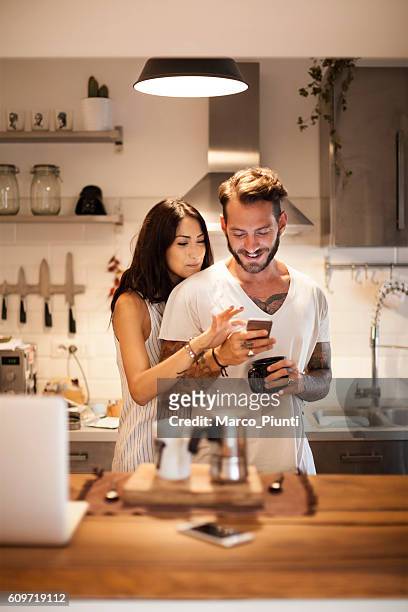 young couple at home using smartphone - morning breakfast time - talk phone flat imagens e fotografias de stock