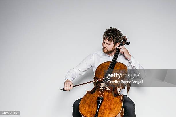 cello player - cellist stock pictures, royalty-free photos & images