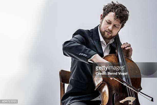 cello player - musician stock pictures, royalty-free photos & images