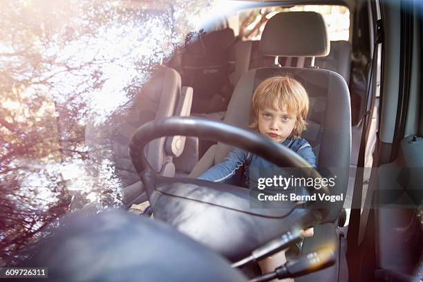 boy enjoying nature - young child car driving stock-fotos und bilder