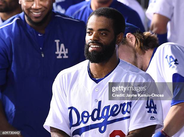 Andrew Toles of the Los Angeles Dodgers is greeted in the dugout after scoring a run in the ninth inning of the game against the San Francisco Giants...