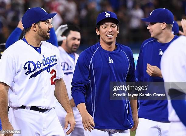 Rob Segedin of the Los Angeles Dodgers and Kenta Maeda walk off the field after the game against the San Francisco Giants at Dodger Stadium on...