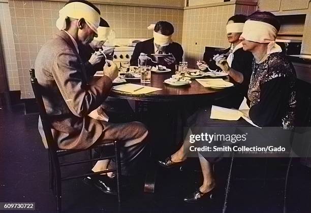 Men and women in a blindfolded focus group participate in a taste test of meats in a mock kitchen at the Department of Agriculture, Beltsville,...