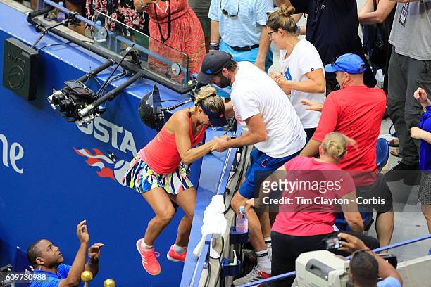 Open - Day 13 Angelique Kerber of Germany climbs into her team box to celebrate her win against Karolina Pliskova of the Czech Republic in the...