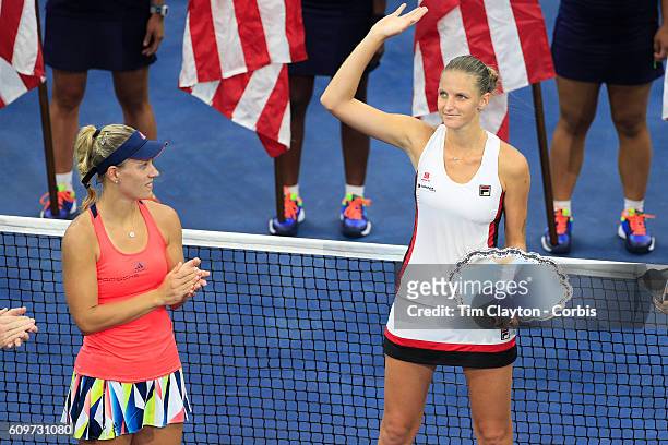 Open - Day 13 Karolina Pliskova of the Czech Republic receives her runners up trophy while being congratulated by winner Angelique Kerber of Germany...