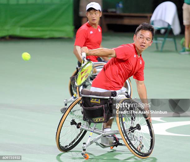 Takeshi Sanada of Japan plays a back hand during the Wheelchair Tennis Men's Doubles Semifinal against Stephane Houdet and Nicolas Peifer of France...