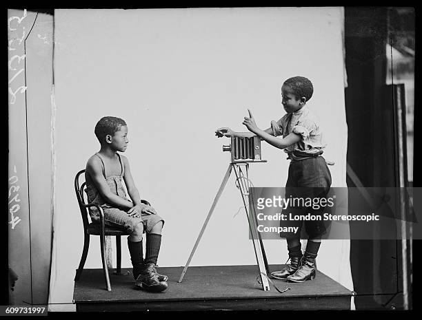 South African singers Albert Jonas and John Xiniwe, of The African Choir, in a staged photographic portrait session, 1891. The choir, drawn from...