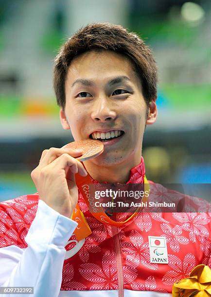 Bronze medalist Takuro Yamada of Japan poses for photographs after the medal ceremony for the Men's 50m Freestyle - S9 Final on day 6 of the 2016 Rio...