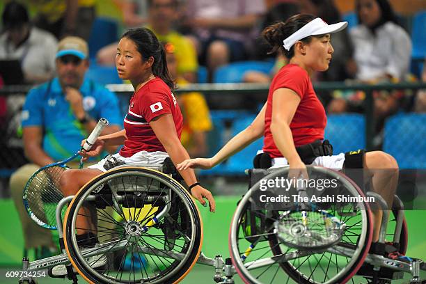 Yui Kamji and Miho Nijo of Japan low fives in the Women's Doubles Bronze Medal Match against Lucy Shuker and Jordanne Whiley of Great Britain on day...