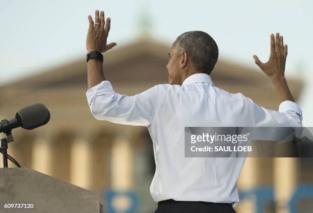 President Barack Obama puts his hands in the air as he speaks during a rally for Democratic Presidential Nominee Hillary Clinton at Eakins Oval in...