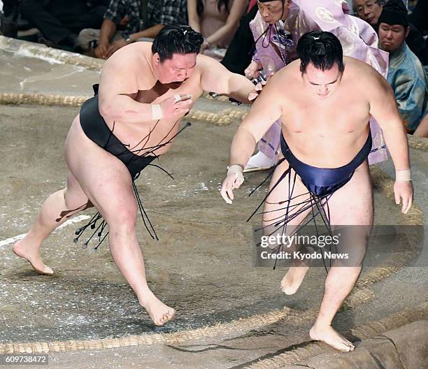 Ozeki Goeido forces yokozuna Kakuryu of Mongolia out of the ring on the 12th day of the Autumn Grand Sumo Tournament at Tokyo's Ryogoku Kokugikan on...