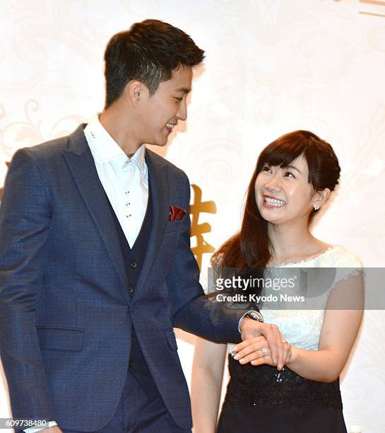 Japanese table tennis icon Ai Fukuhara and her Taiwanese husband Chiang Hung-chieh, also a table tennis player, pose for photos during a press...