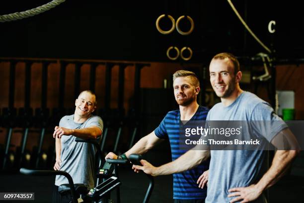 smiling men in discussion during break in workout - 3 gym stock pictures, royalty-free photos & images