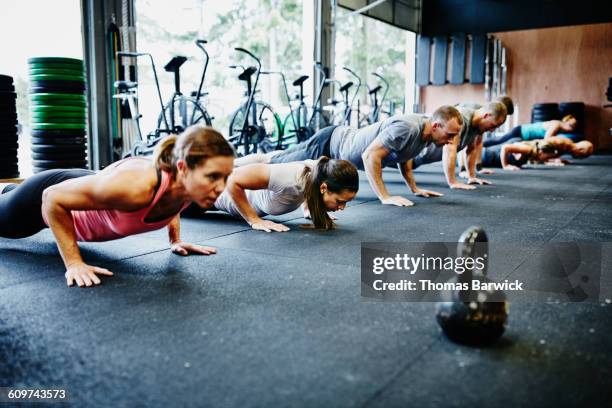 friends doing pushups during workout in gym - cross training stock pictures, royalty-free photos & images