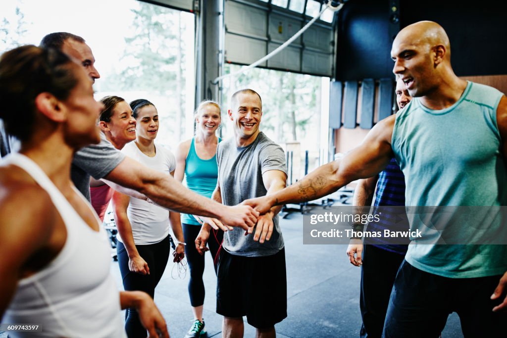 Group of friends celebrating together in gym