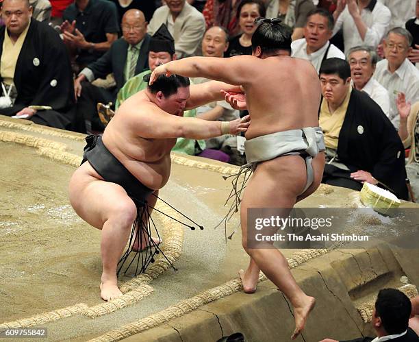 Ozeki Goeido pushes Mongolian wrestler Takanoiwa to win during day four of the Grand Sumo Autumn Tournament at Ryogoku Kokugikan on September 14,...