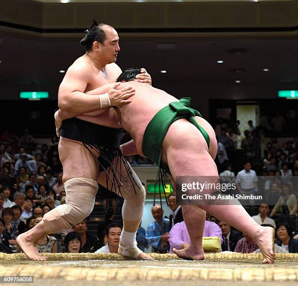 Wakanoshima pushes Aminishiki out of the ring to win in the Juryo rank bout during day four of the Grand Sumo Autumn Tournament at Ryogoku Kokugikan...