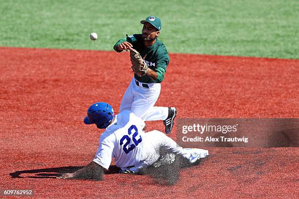 Irait Chirino of Team Brazil slides into second base breaking up a double play as Faquir Hussain of Team Pakistan throws to first base during Game 1...