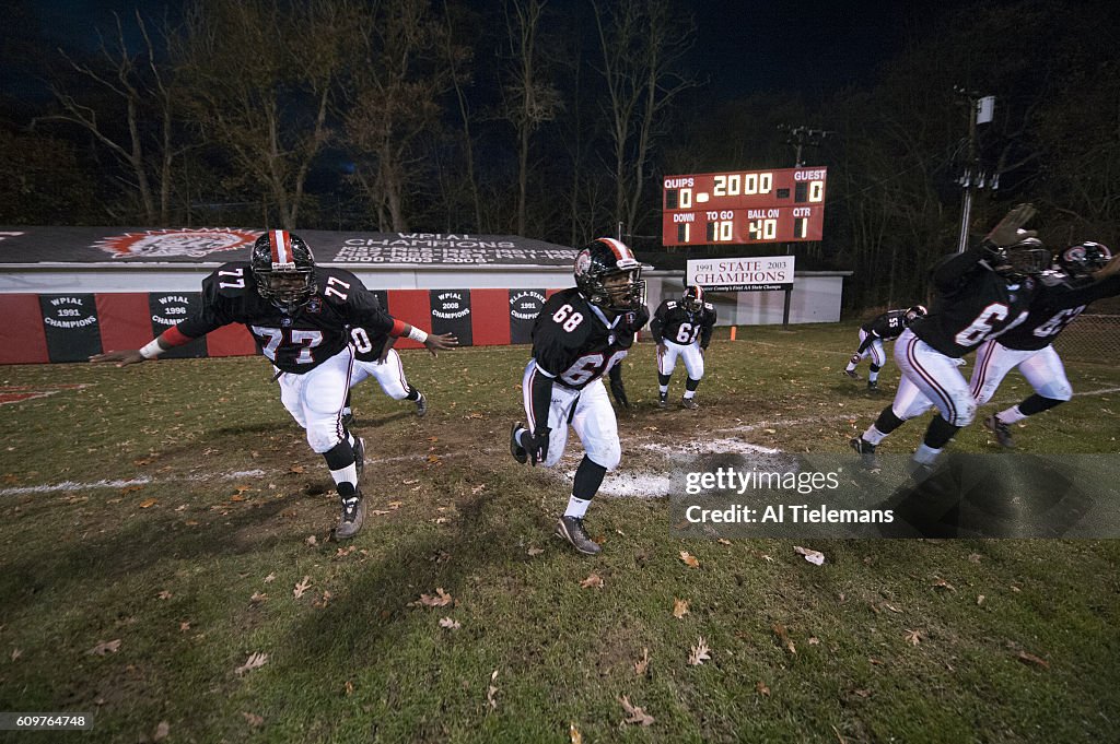 View of Aliquippa High players taking the field before game vs Shady