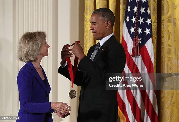 President Barack Obama presents the National Humanities Medal to historian Elaine Pagels during an East Room ceremony at the White House September...