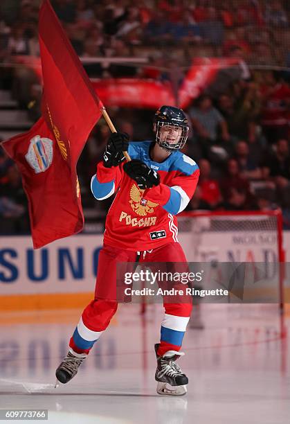 Flag bearer welcomes Team Russia prior to the game against Team Finland during the World Cup of Hockey 2016 at Air Canada Centre on September 22,...