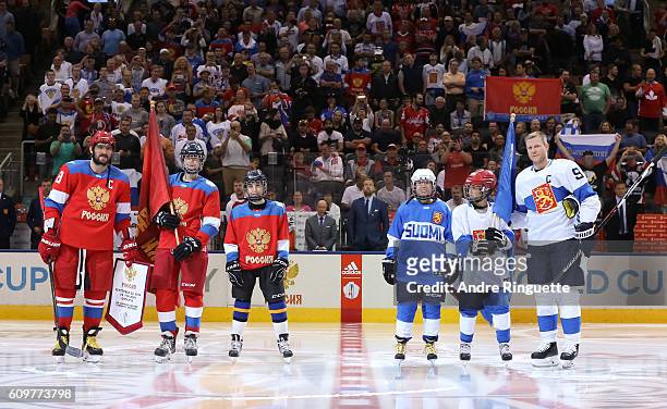 Alex Ovechkin of Team Russia exchanges team flags with Mikko Koivu of Team Finland during the World Cup of Hockey 2016 at Air Canada Centre on...
