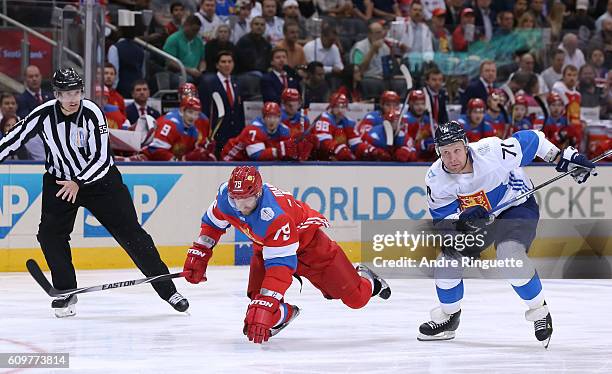 Andrei Markov of Team Russia falls to the ice with Leo Komarov of Team Finland chasing during the World Cup of Hockey 2016 at Air Canada Centre on...