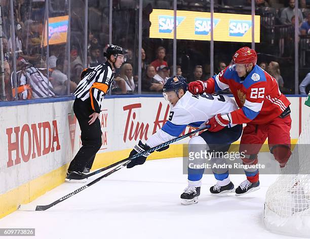 Mikko Koivu of Team Finland pulls the puck away from Nikita Zaitsev of Team Russia during the World Cup of Hockey 2016 at Air Canada Centre on...