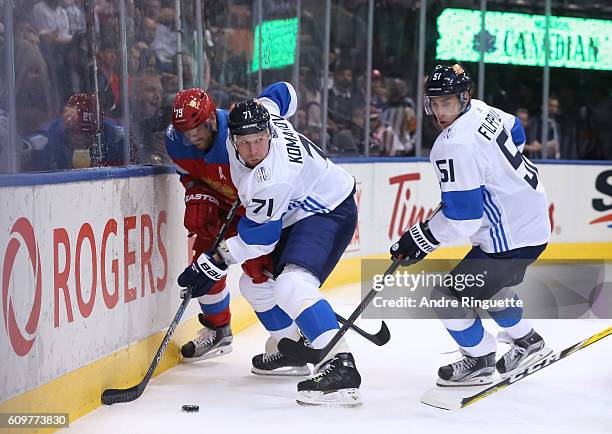 Andrei Markov of Team Russia battles for the puck with Leo Komarov and Valtteri Filppula of Team Finland during the World Cup of Hockey 2016 at Air...