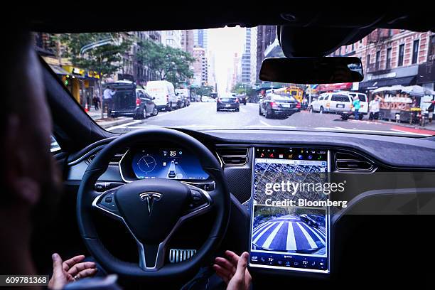 Driver rides hands-free in a Tesla Motors Inc. Model S vehicle equipped with Autopilot hardware and software in New York, U.S. On Monday, Sept. 19,...