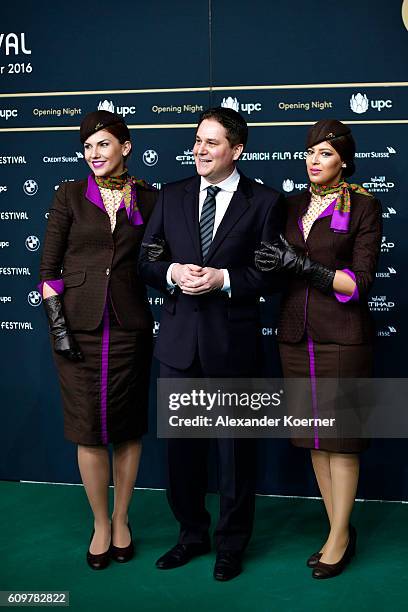 Peter Baumgartner, Etihad Airways chief commercial officer, and two hostesses attend the 'Lion' premiere and opening ceremony of the 12th Zurich Film...