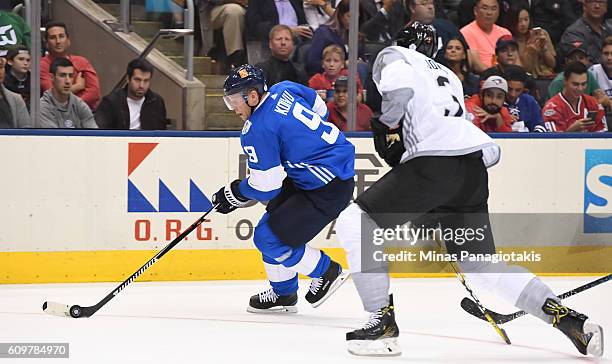 Mikko Koivu of Team Finland stickhandles the puck with Seth Jones of Team North America chasing during the World Cup of Hockey 2016 at Air Canada...
