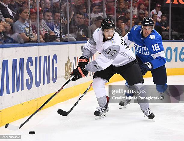 Johnny Gaudreau of Team North America stickhandles the puck with Sami Lepisto of Team Finland chasing during the World Cup of Hockey 2016 at Air...