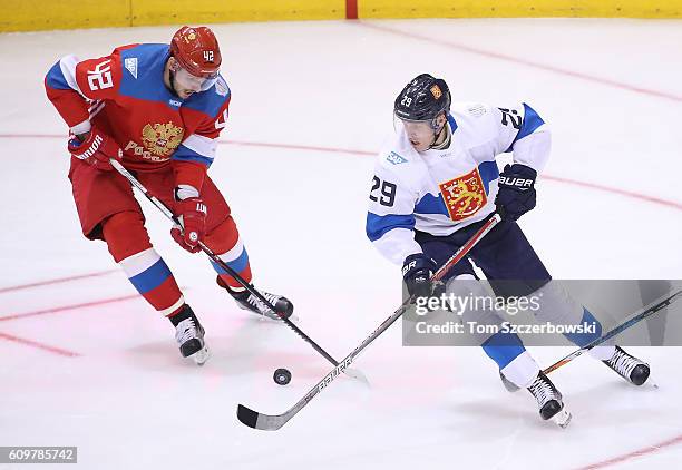 Artem Anisimov of Team Russia battles for control of the puck with Patrik Laine of Team Finland during the World Cup of Hockey tournament at the Air...