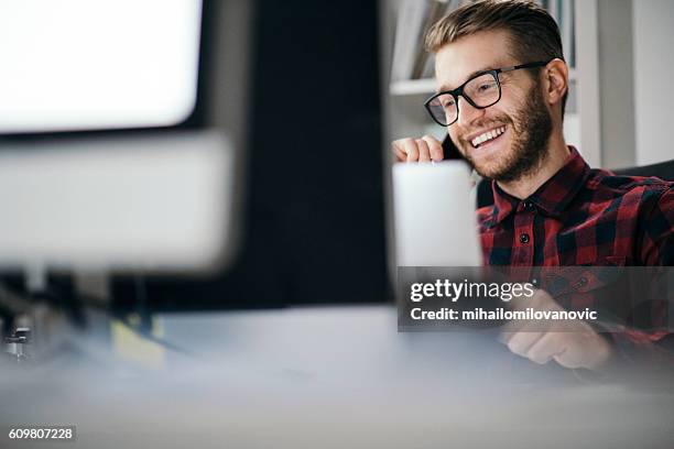 man having an exciting call in the office - cool office stockfoto's en -beelden