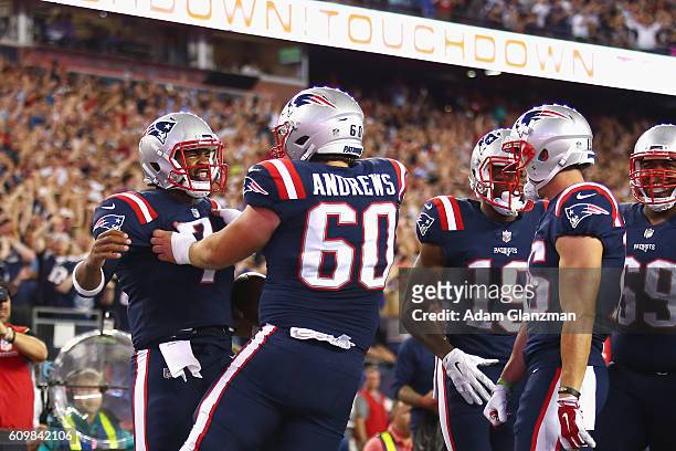 Jacoby Brissett of the New England Patriots celebrates with teammates after scoring a touchdown during the first quarter against the Houston Texans...