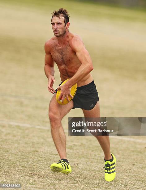 Jobe Watson runs with the ball after speaking to the media about his AFL playing future during an Essendon Bombers AFL media session at St Bernard's...