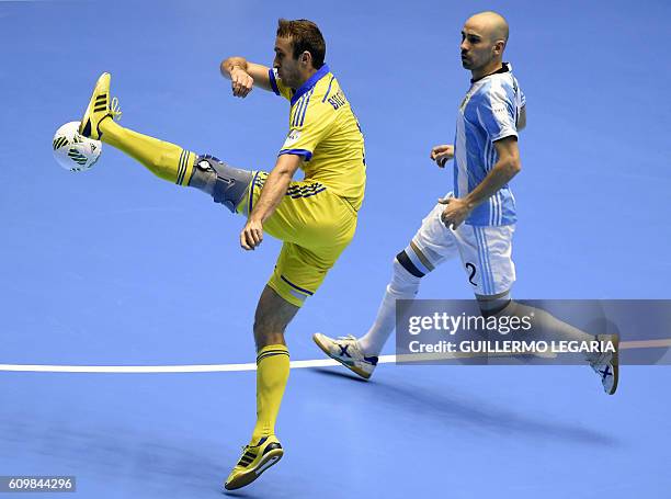Argentina's Damian Stazzone vies for the ball with Ukraine's Mykola Bilotserkivets during their Colombia 2016 FIFA Futsal World Cup match in...