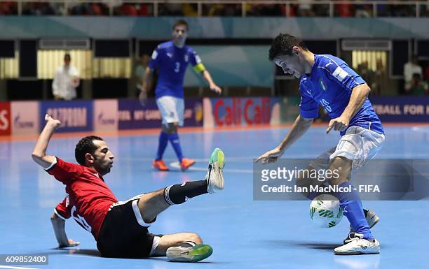 Mostafa Nader of Egypt vies with Alex Merlim of Italy during the FIFA Futsal World Cup Round of 16 match between Italy and Egypt at the Coliseo el...