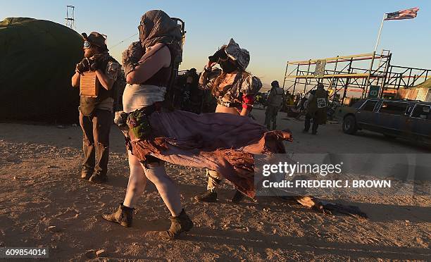 Festival goers attend the first day of Wasteland Weekend in the high desert community of California City in the Mojave Desert, California, where...